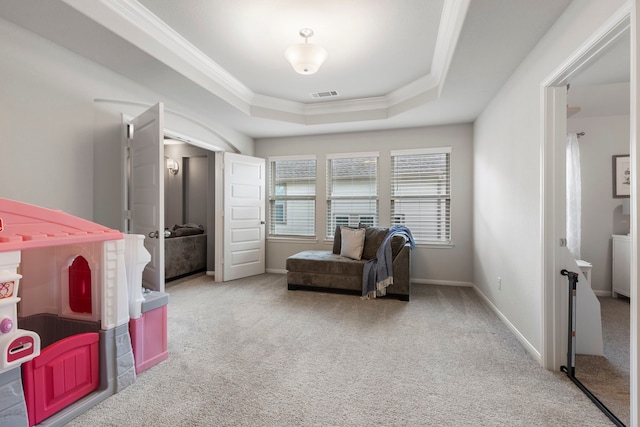 sitting room with a raised ceiling, light carpet, and crown molding