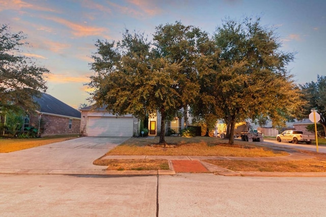 view of property hidden behind natural elements with a garage