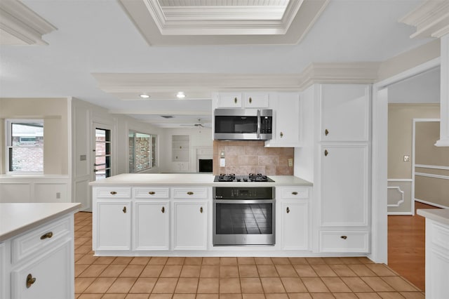 kitchen with stainless steel appliances, white cabinetry, and light tile patterned floors