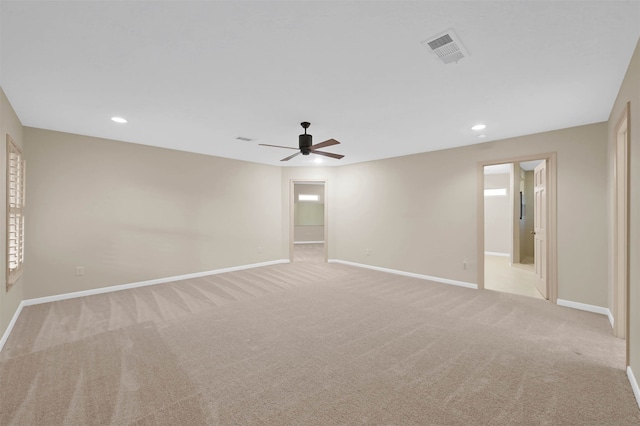 carpeted spare room featuring ceiling fan