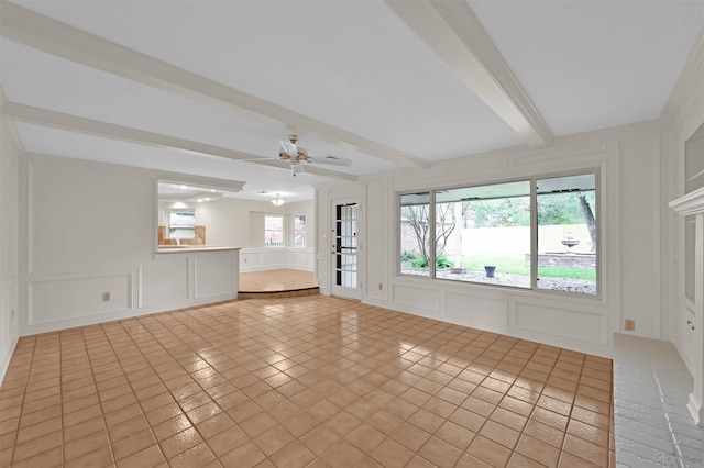 unfurnished living room featuring ceiling fan, light tile patterned flooring, and beamed ceiling