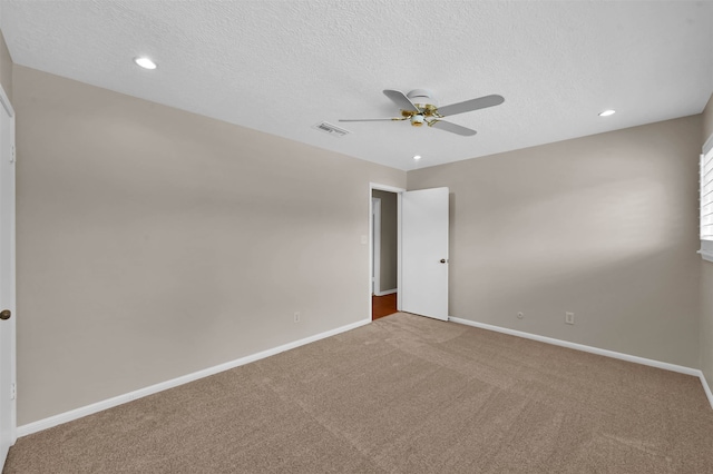 unfurnished bedroom featuring ceiling fan, a textured ceiling, and carpet