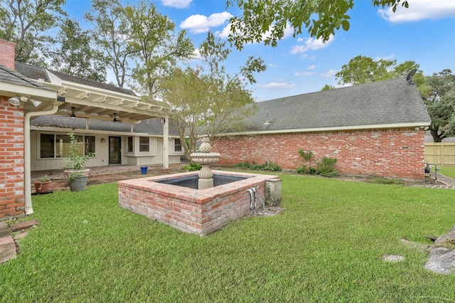 view of yard featuring ceiling fan and a patio