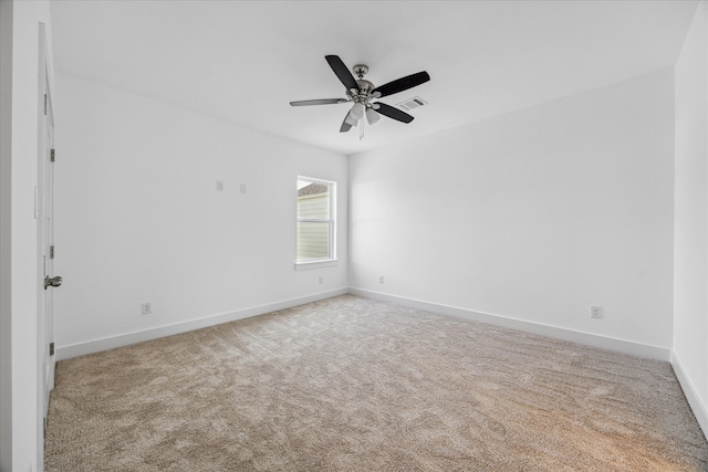 empty room featuring ceiling fan and light colored carpet