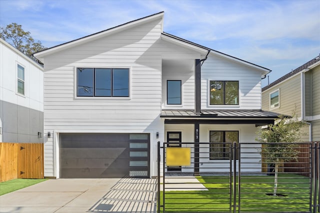 view of front of property with covered porch, a garage, and a front lawn