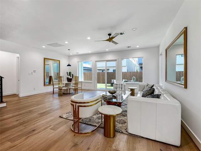 living room featuring ceiling fan and light wood-type flooring