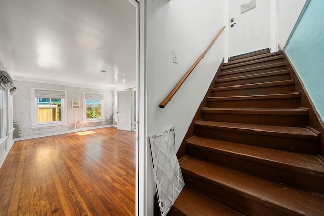 stairs featuring hardwood / wood-style floors