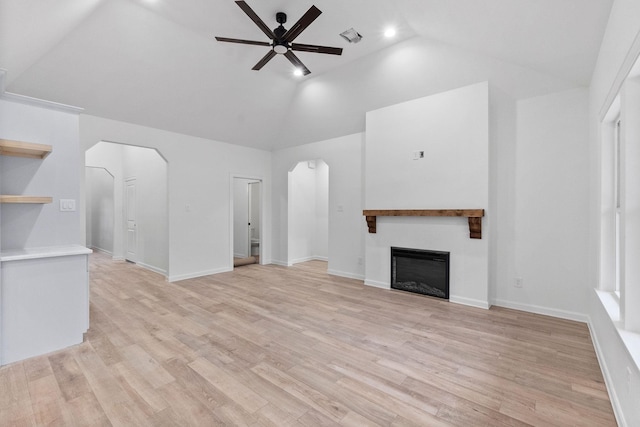 unfurnished living room featuring light hardwood / wood-style flooring, ceiling fan, and vaulted ceiling