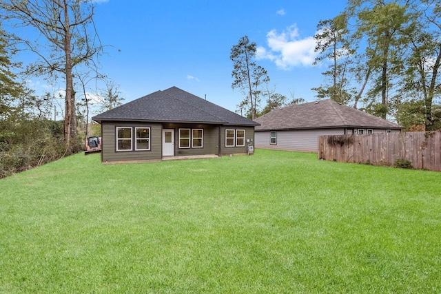 rear view of house with a lawn