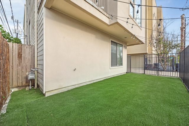 exterior space with a lawn and a balcony