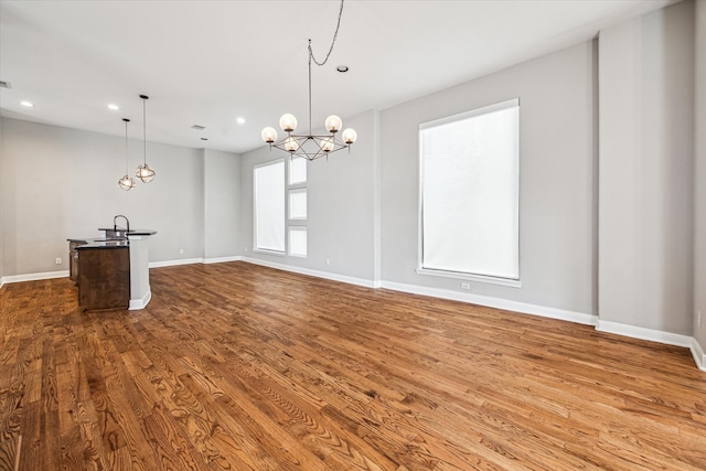 interior space featuring wood-type flooring and a notable chandelier