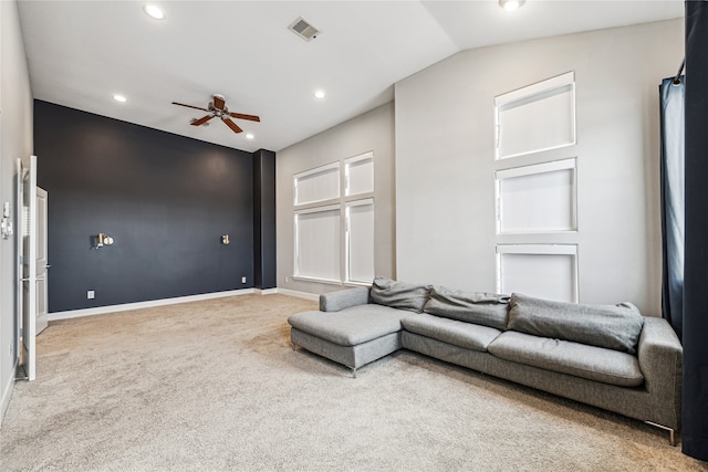 living room with ceiling fan, lofted ceiling, and carpet