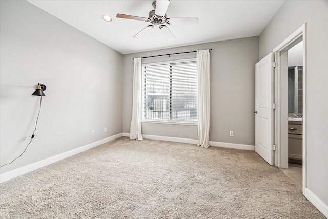 unfurnished bedroom featuring light carpet and ceiling fan