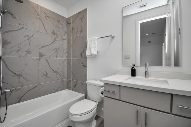 full bathroom featuring toilet, tiled shower / bath combo, and vanity