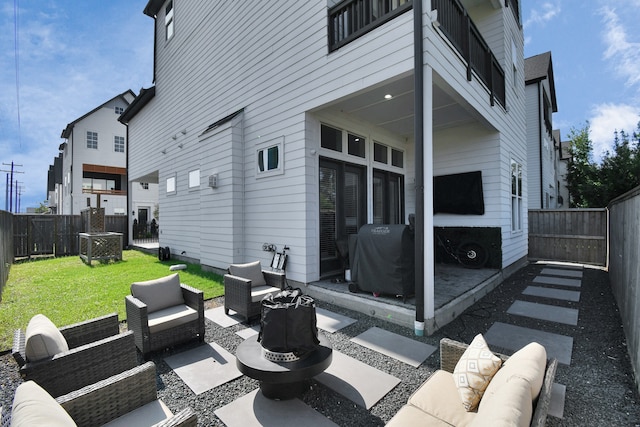 view of patio / terrace with a balcony, area for grilling, and an outdoor living space