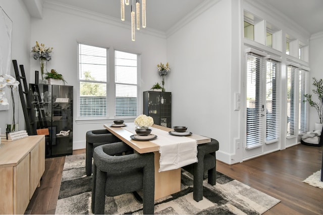 dining room with dark hardwood / wood-style floors and crown molding