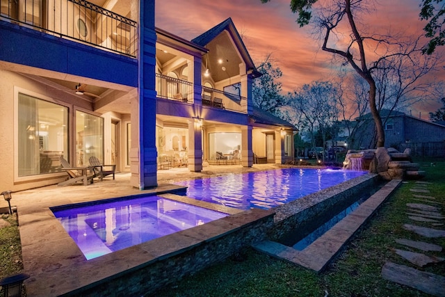 66 Bees Creek Rd, Missouri City, TX 77459 - pool at dusk with an in-ground hot tub, a patio, and an outdoor pool