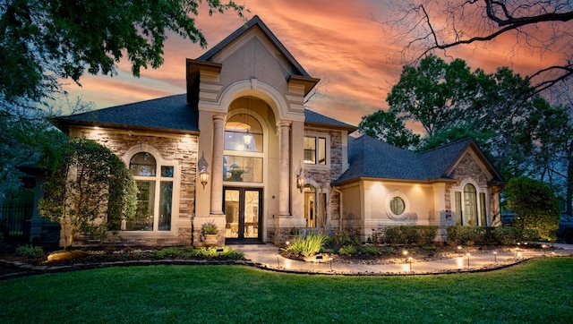 view of front of property featuring a yard and french doors