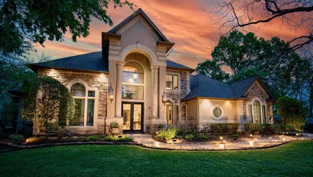 66 Bees Creek Rd, Missouri City, TX 77459 - view of front of property with french doors, stone siding, stucco siding, and a front yard
