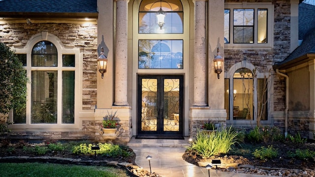 66 Bees Creek Rd, Missouri City, TX 77459 - property entrance with stone siding, french doors, and a shingled roof