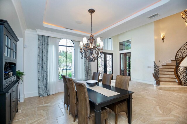 66 Bees Creek Rd, Missouri City, TX 77459 - dining area with a chandelier, a tray ceiling, light stone finish flooring, and stairs