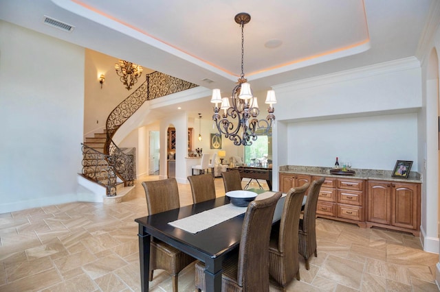 66 Bees Creek Rd, Missouri City, TX 77459 - dining area with a chandelier, stairway, a tray ceiling, baseboards, and light stone finish flooring