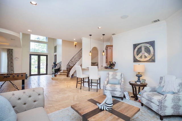 living room with crown molding and french doors