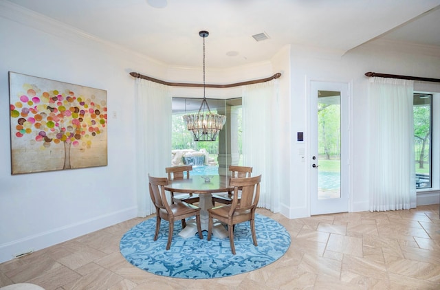 dining room featuring an inviting chandelier and crown molding