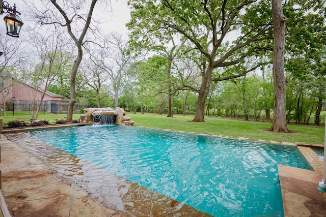 view of pool featuring a lawn and pool water feature