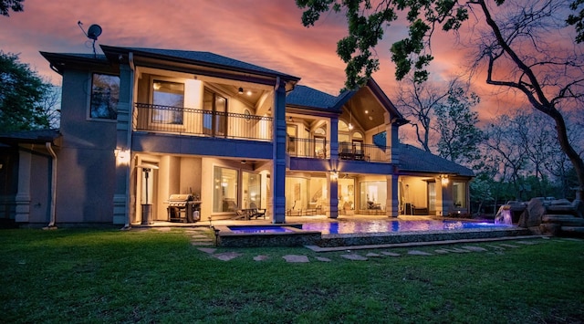 66 Bees Creek Rd, Missouri City, TX 77459 - rear view of property with a balcony, stucco siding, a lawn, and a patio
