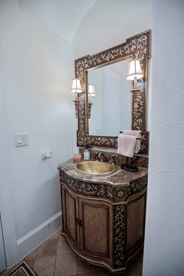 bathroom with vanity and lofted ceiling