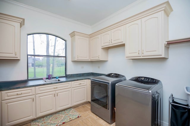 clothes washing area featuring cabinets, light tile patterned floors, sink, ornamental molding, and washer and dryer