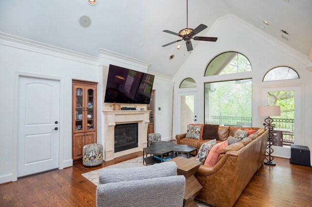 living room featuring high vaulted ceiling, dark wood-type flooring, ceiling fan, and crown molding