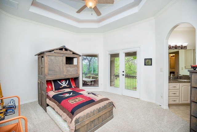 carpeted bedroom with access to outside, french doors, crown molding, ceiling fan, and ensuite bathroom