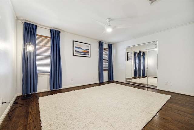 unfurnished room featuring ceiling fan and dark hardwood / wood-style floors