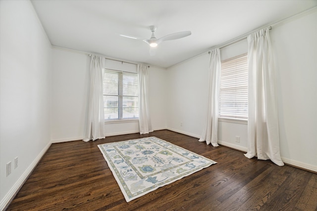 empty room with ceiling fan and dark hardwood / wood-style floors