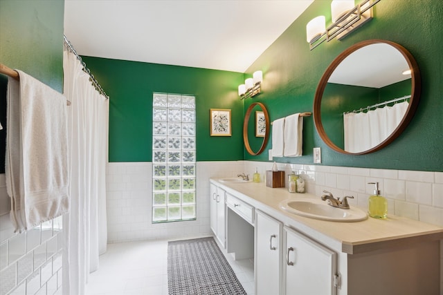 bathroom featuring tile walls, tile patterned flooring, and vanity