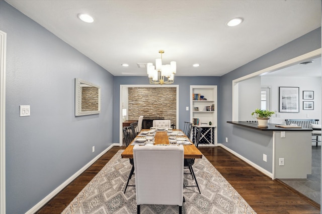 dining room featuring dark hardwood / wood-style flooring and an inviting chandelier