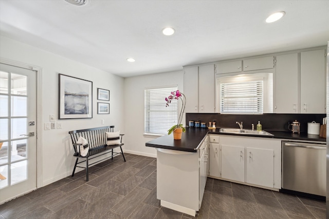 kitchen featuring white cabinetry, plenty of natural light, stainless steel dishwasher, and sink