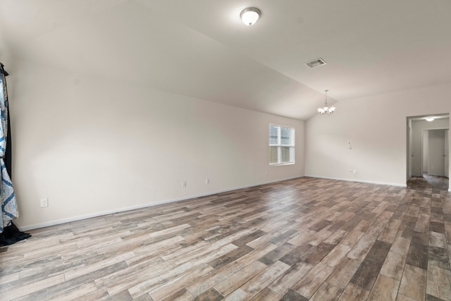 interior space featuring lofted ceiling, an inviting chandelier, and light hardwood / wood-style flooring