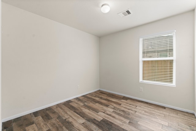 spare room with hardwood / wood-style floors