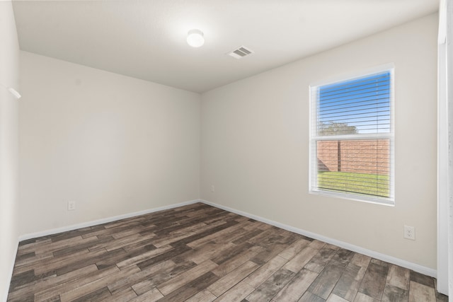 unfurnished room featuring dark wood-type flooring