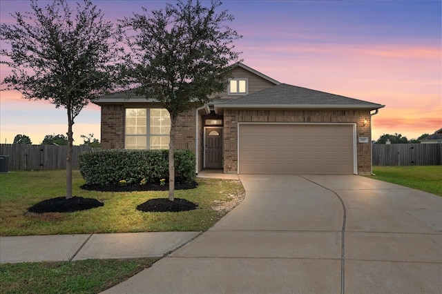 view of front facade with a yard and a garage