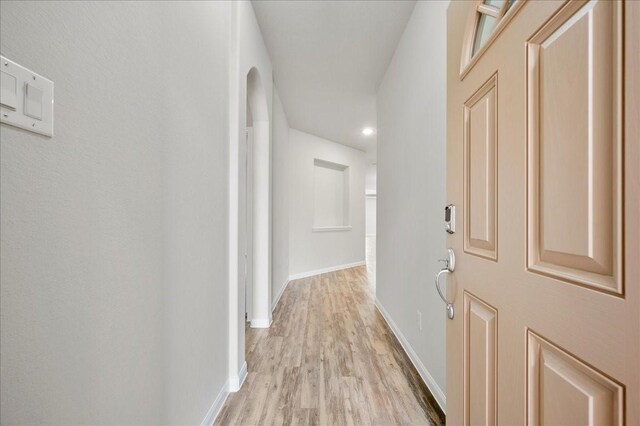 hallway with light wood-type flooring