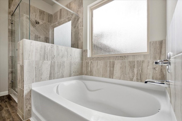 bathroom featuring independent shower and bath and wood-type flooring