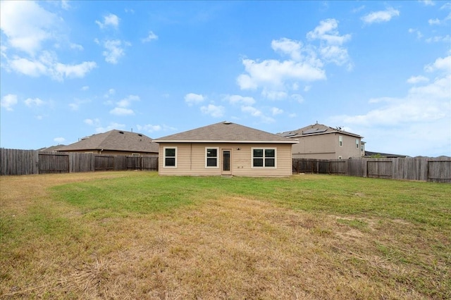 rear view of property with a yard