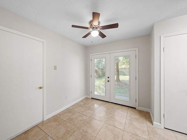 doorway featuring french doors, light tile patterned floors, and ceiling fan