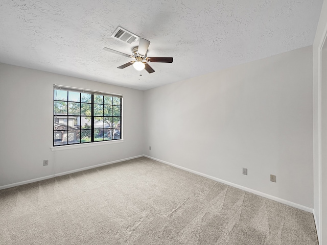 unfurnished room featuring a textured ceiling, ceiling fan, and carpet floors