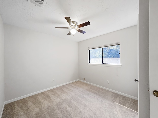 carpeted spare room with ceiling fan