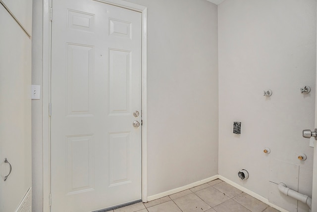 laundry room featuring gas dryer hookup and light tile patterned floors